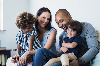 The Callahan family sits together at home.