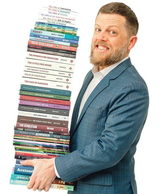 Connor Boyack holding a stack of his books.