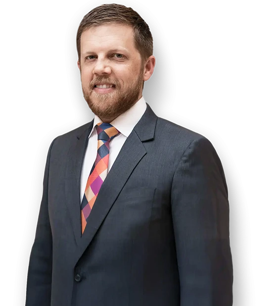 Connor Boyack standing in a suit.