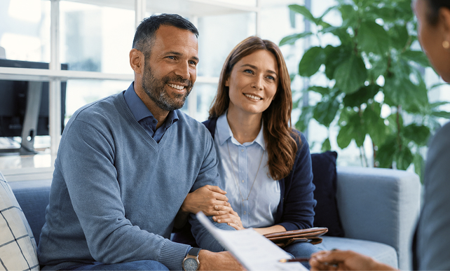 A couple meets with an advisor to discuss family coaching.